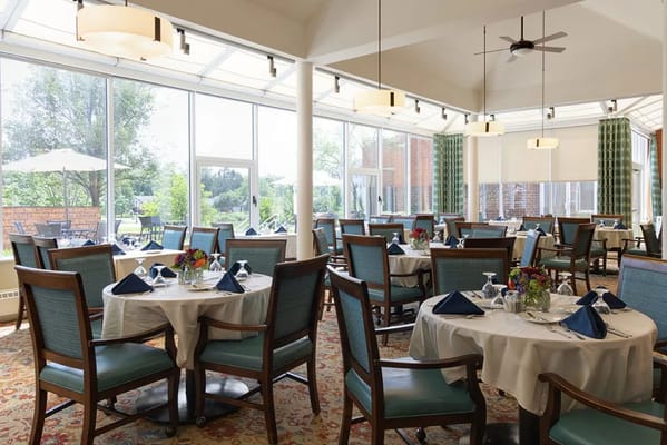 Bright dining room with tables set for meals