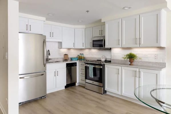 Modern kitchen with stainless steel appliances and white cabinetry