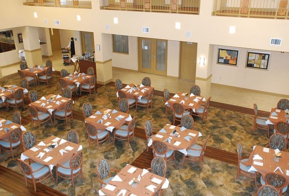 Interior view of the dining room with tables set for meals