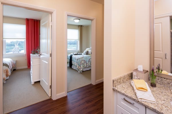 View of two bedrooms with a shared bathroom