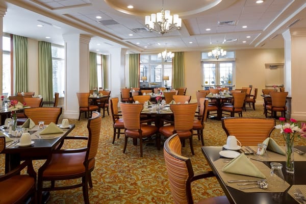 Interior view of the dining room with tables set for meals
