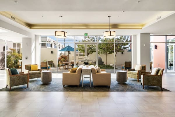 Bright lounge area with comfortable seating and large windows