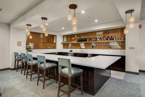 Modern bar with seating and drinks display at Valley Vista Senior Living