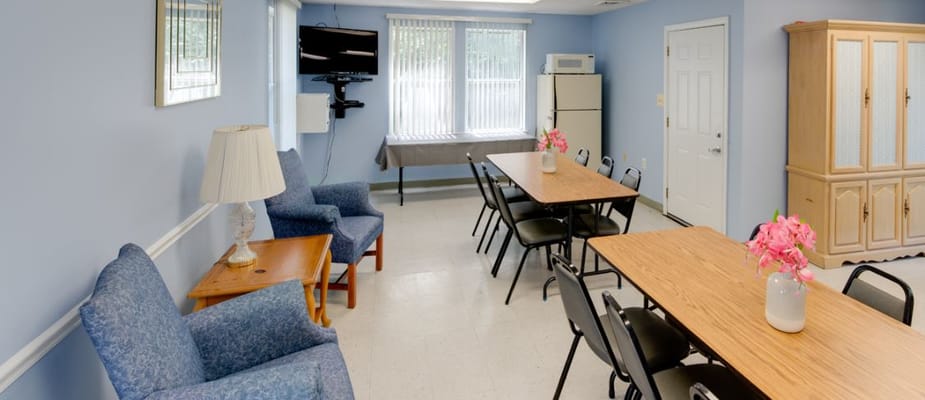 Spacious common room with seating and dining tables