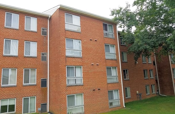 Exterior of Victory Brookside senior living facility showing brick facade and windows.