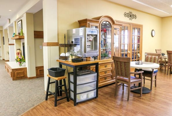 Interior view of the common area with seating and a refreshment station.