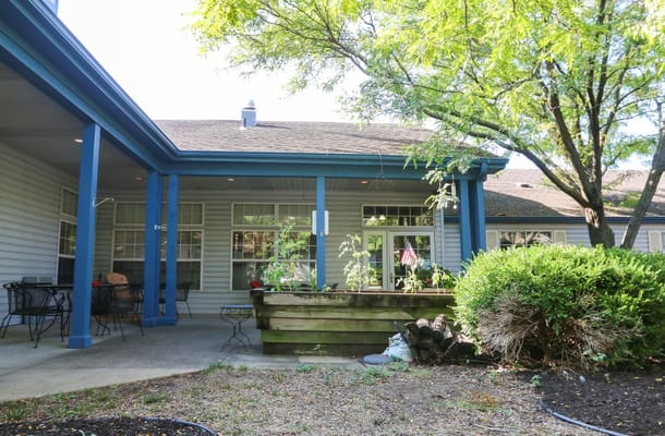Patio area with chairs and raised garden beds