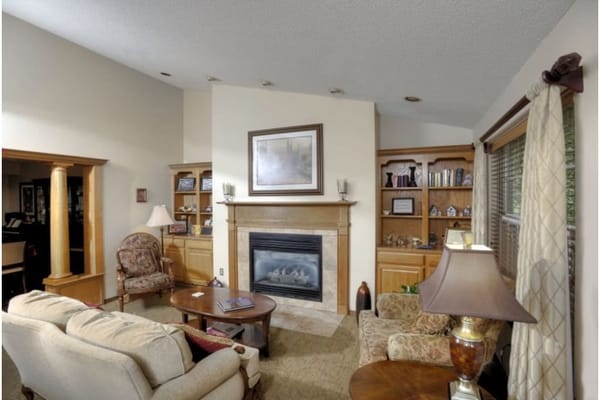 Inviting living room with a fireplace and bookshelves