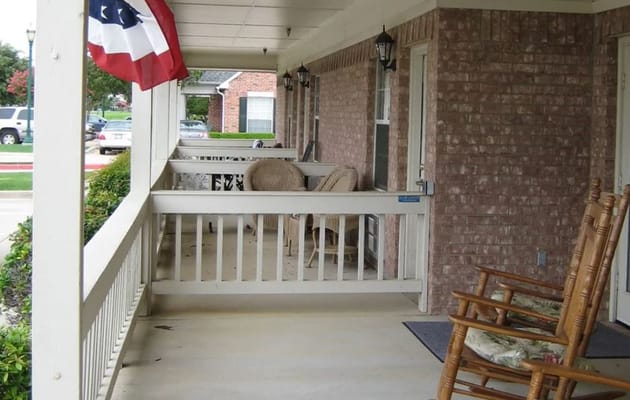 Covered porch area with rocking chairs