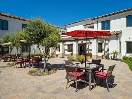 Outdoor seating area with tables and umbrellas
