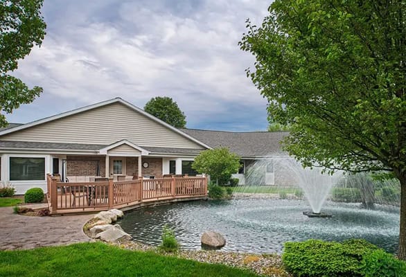 Exterior view of the facility with a pond and fountain