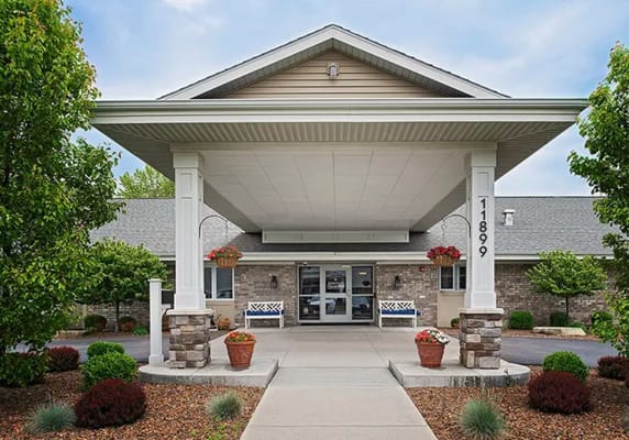 Front entrance of a senior living facility with landscaping