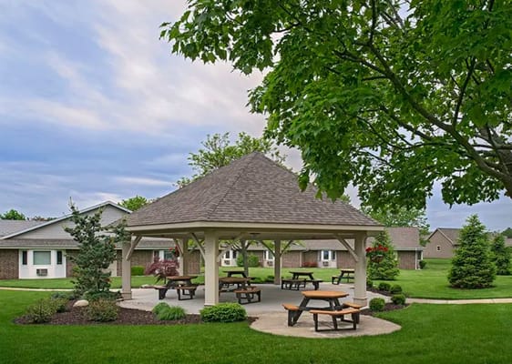 Outdoor gazebo area with picnic tables in a senior community