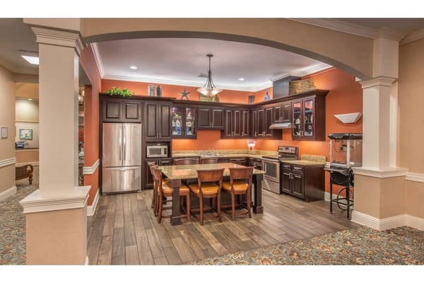 Spacious kitchen area with dark cabinets and granite countertops