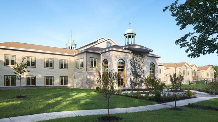 Exterior of Milwaukee Catholic Home featuring landscaped garden.