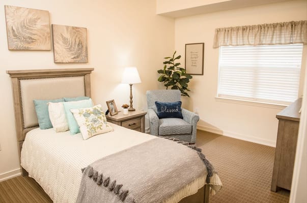 Cozy private room with a bed and chair