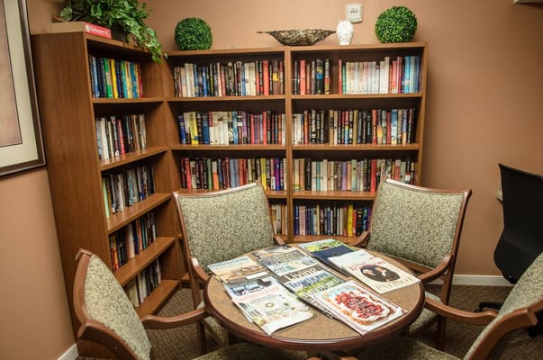 Cozy reading area with bookshelves and magazines