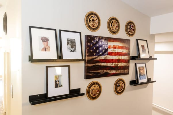 Interior wall displaying an American flag and framed photos