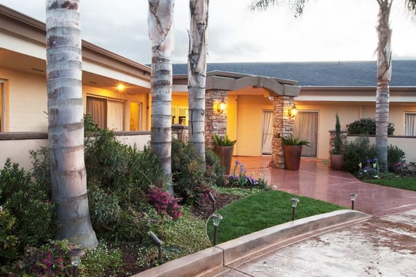 Exterior view of Cottonwood Canyon Healthcare Center with palm trees