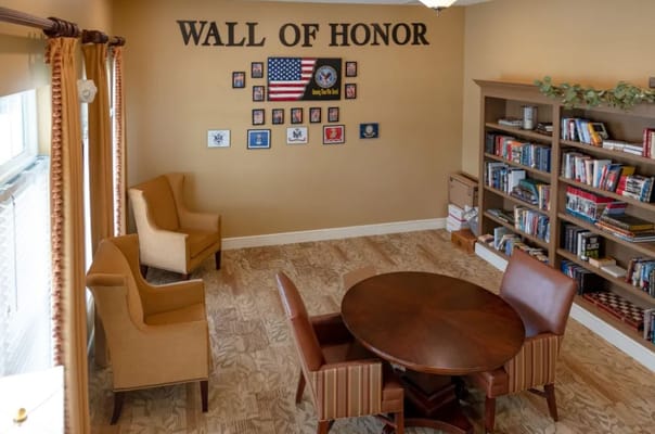 Common area with a Wall of Honor and bookshelves