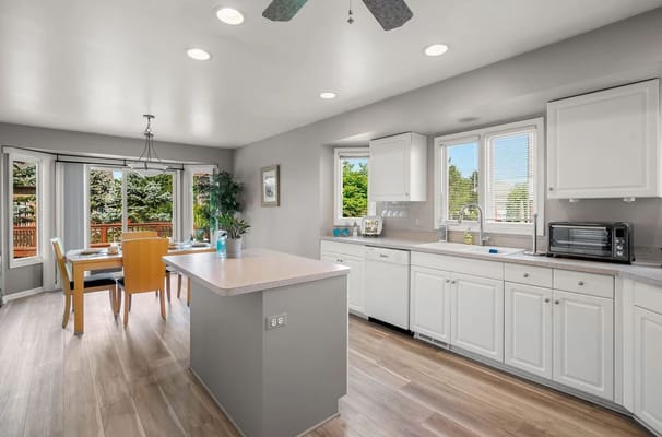 Modern kitchen with dining area and large windows