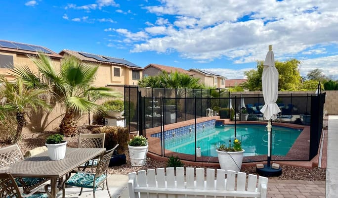 Outdoor patio with pool and palm trees