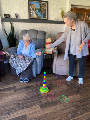 Residents engaging in a ring toss activity in a common area