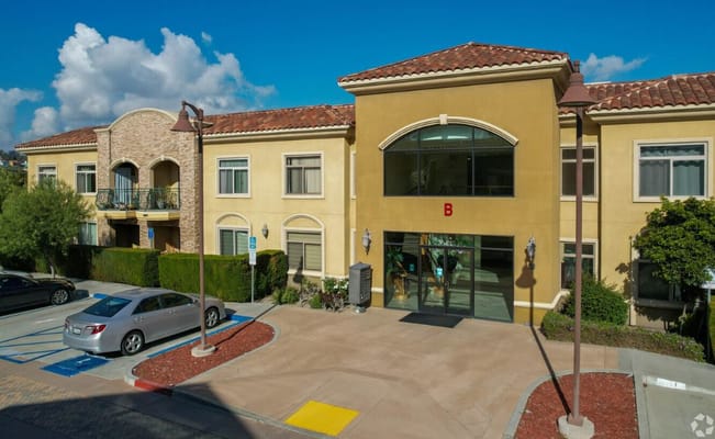 Main entrance to Ivy Garden Senior Condos with decorative architecture.