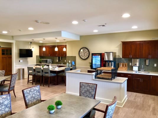 Bright kitchen and dining area with seating and modern appliances.