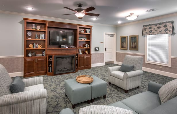 Bright common area with comfortable seating and a TV