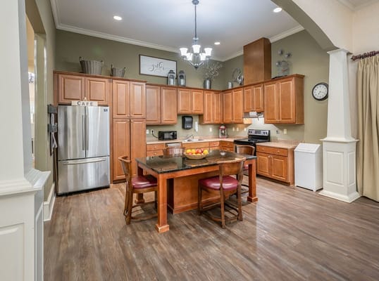 Bright, spacious kitchen area with wooden cabinets