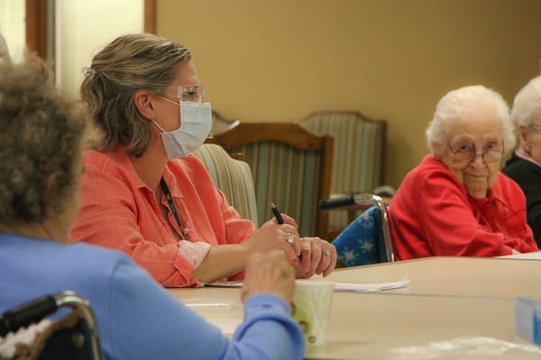 Residents and staff engaged in a group activity in a common area