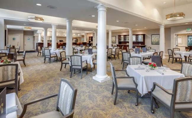 Dining room with tables and chairs set up for meals