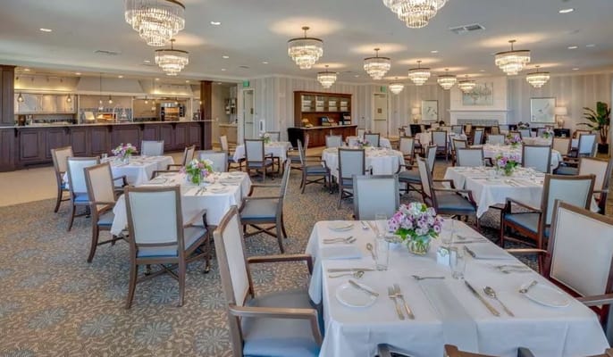 Elegant dining room setup with tables and flowers