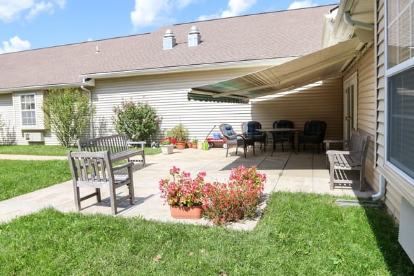 Cozy outdoor patio with seating and flowers at Vintage Park