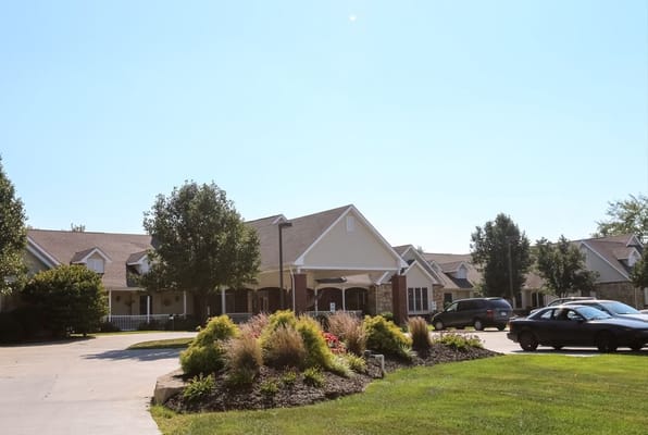 Exterior of Vintage Park at Paola showing landscaped entrance and vehicles