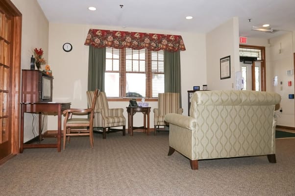 Living room area with comfortable seating and a desk