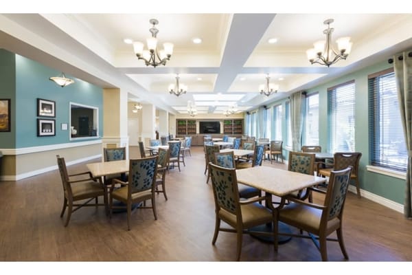 Bright and spacious common area with tables and chairs