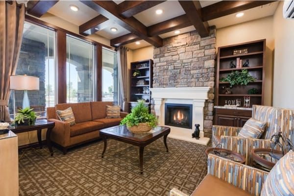 Warm and inviting common area with seating and fireplace
