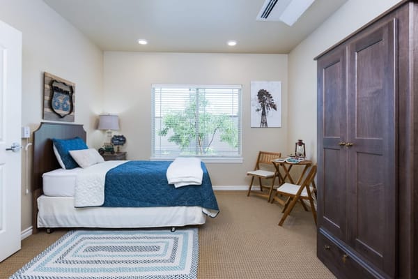 Cozy resident room with a bed and window view