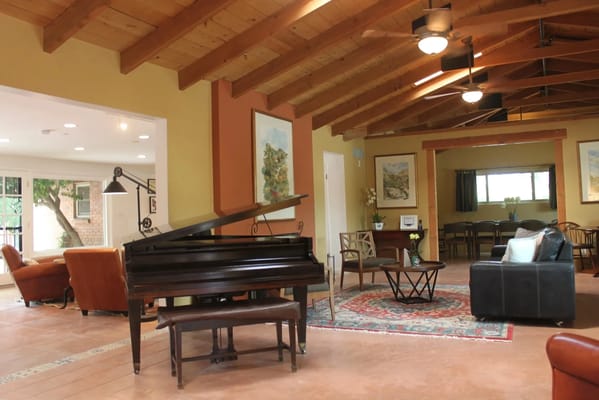 Cozy common area with a piano and seating