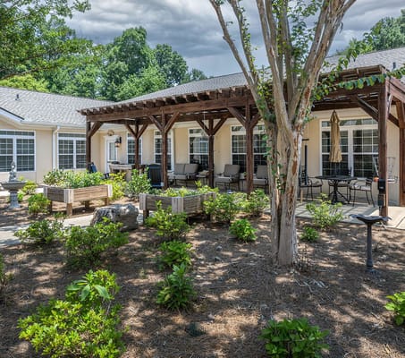 Outdoor patio area with seating and landscaping