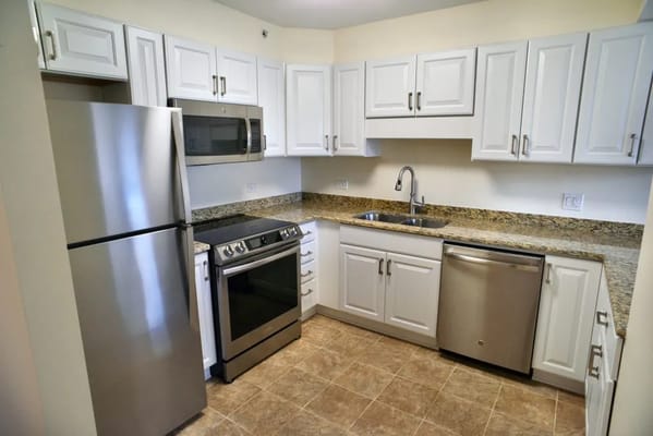 A bright, modern kitchen with stainless steel appliances and granite countertops.
