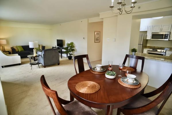 Cozy dining area with a table set for four and a view of the living space.