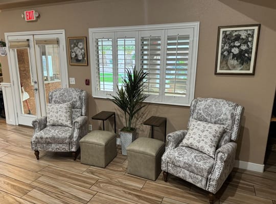 Cozy lounge with floral chairs and side tables