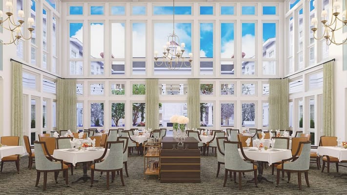Elegant dining room with large windows and tables set for meals