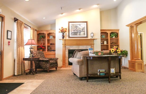 Living room with comfortable seating and decorative shelves.