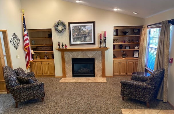 Cozy common area with chairs and a fireplace