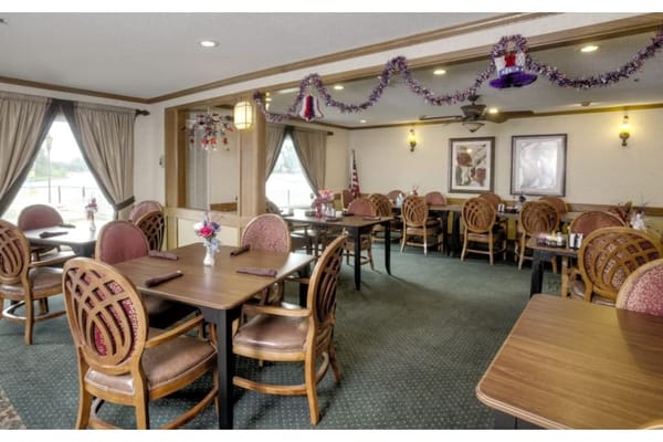 Cozy dining area with tables and chairs decorated for a festive occasion