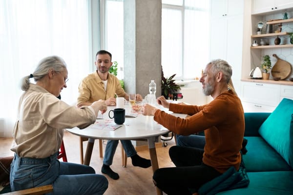 Residents and staff engaging in an activity around a table